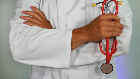 A doctor holding a stethascope 